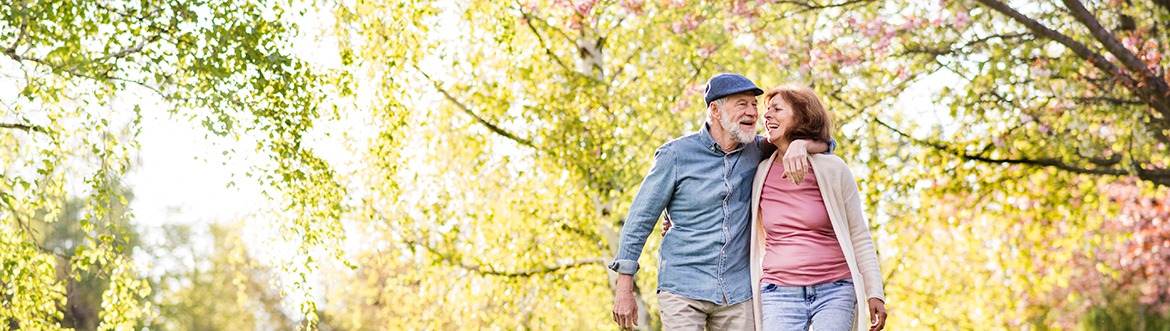 Senior couple hugging while on a walk