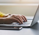 Person typing on computer