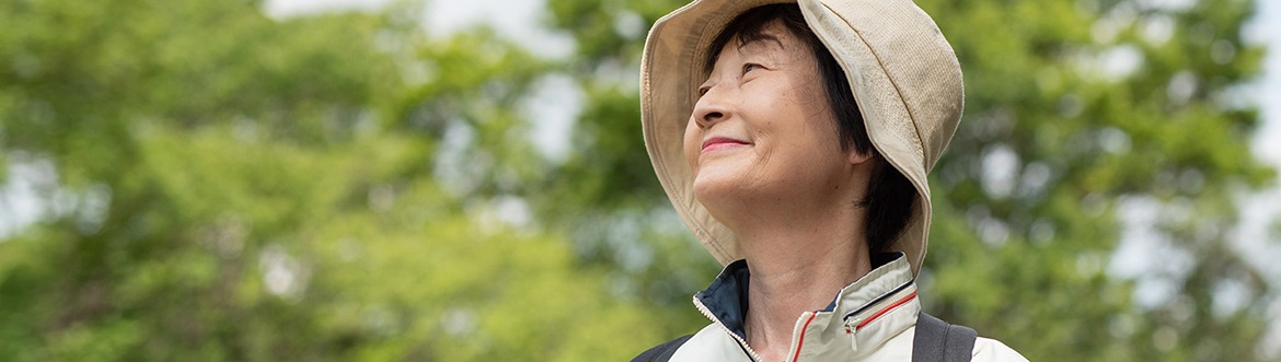 Woman in nature looking at the sky