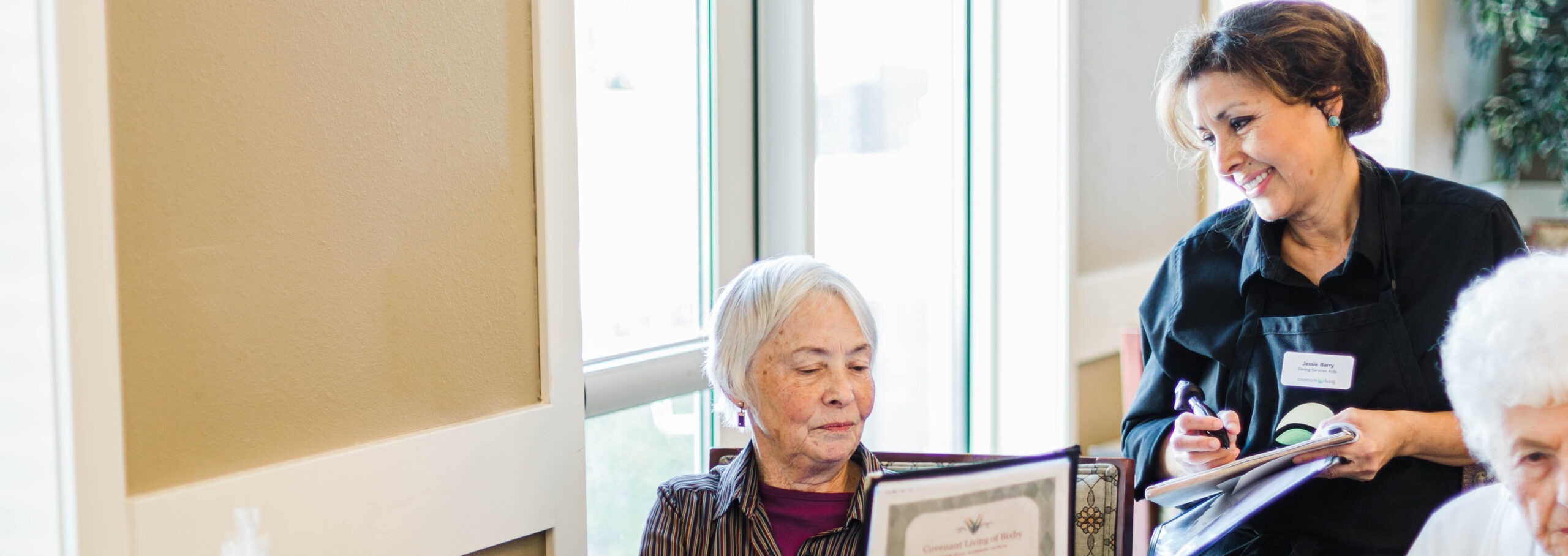 Employee helping resident review documents