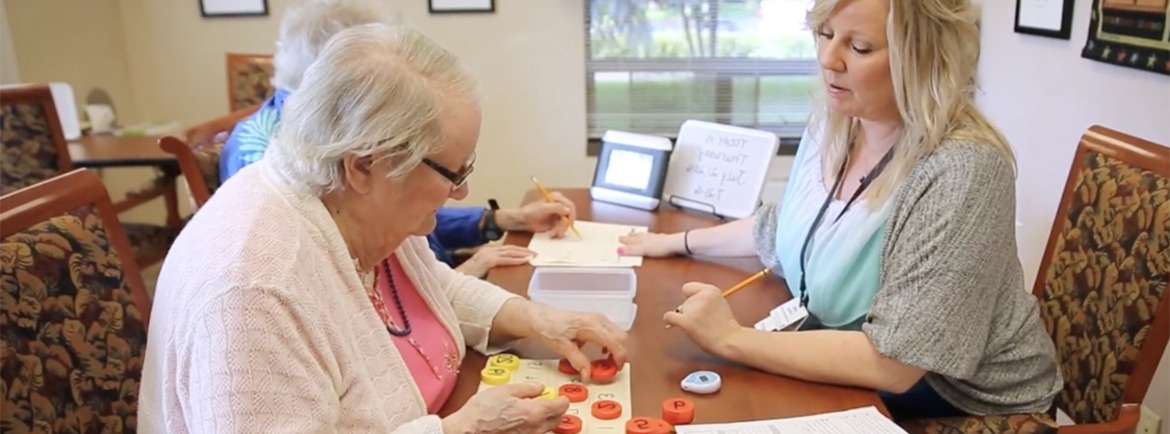 Woman assisting resident with SAIDO learning