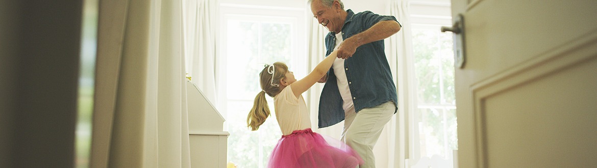 Senior dancing with granddaughter dressed as a princess